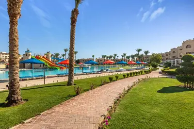 a resort with a swimming pool and palm trees at Royal Lagoons Resort & Aqua Park Families and Couples Only in Hurghada