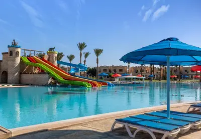 a pool with a water slide in a resort at Royal Lagoons Resort & Aqua Park Families and Couples Only in Hurghada