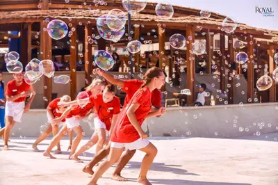 a group of girls in red shirts are playing with bubbles at Royal Lagoons Resort & Aqua Park Families and Couples Only in Hurghada
