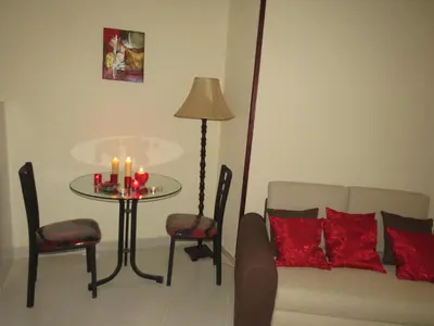 a living room with a couch and a table with candles at Apartment Dolce Vita near the sea RedSeaLine in Hurghada
