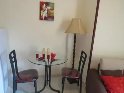 a dining room table with two chairs and a lamp at Apartment Dolce Vita near the sea RedSeaLine in Hurghada