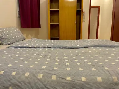 a bed with a blue comforter in a bedroom at Nile Panorama Hotel & Restaurant in Luxor