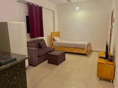 a living room with a couch and a bed at Nile Panorama Hotel & Restaurant in Luxor