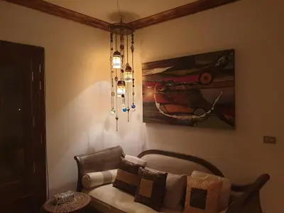 a living room with a couch and a chandelier at Dar Om Ali ElGouna Sabina y160 2 14 in El Gouna