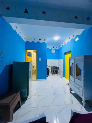 a room with blue walls and a tv in it at Tongel Nubian Studio & Guest House in Aswan