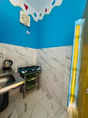a small kitchen with a sink and a counter at Tongel Nubian Studio & Guest House in Aswan