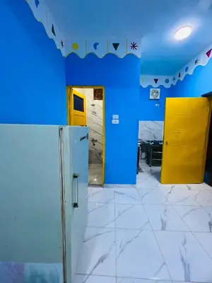 a room with blue walls and a yellow door at Tongel Nubian Studio & Guest House in Aswan