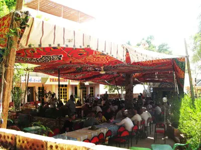 a group of people sitting in chairs under a tent at Pharaohs Hotel in Luxor