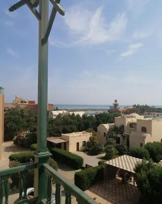 a cross on a balcony with a view of a city at El Gouna abu tig marina Studio p economy stay in Hurghada