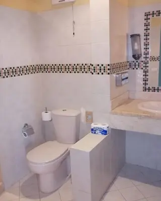 a white bathroom with a toilet and a sink at El Gouna abu tig marina Studio p economy stay in Hurghada