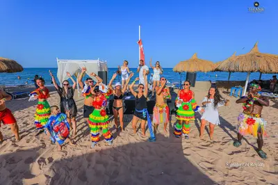a group of people posing for a picture on the beach at Titanic Royal-Families and Couples only in Hurghada