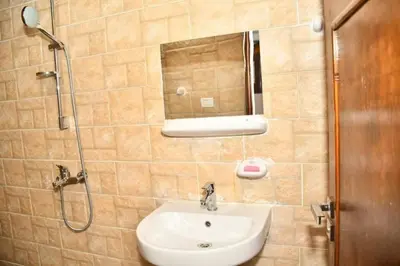 a bathroom with a sink and a shower with a mirror at Om-Abdallah in Aswan