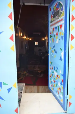 a doorway into a room with a colorful wall at Om-Abdallah in Aswan