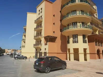 a car parked in front of a large building at EL Gouna Abu tig Studio- Economy stay in Hurghada