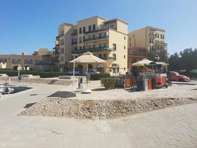 a parking lot with umbrellas in front of a building at EL Gouna Abu tig Studio- Economy stay in Hurghada