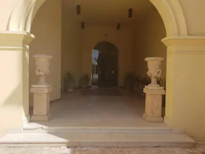 an archway with two white vases in a hallway at EL Gouna Abu tig Studio- Economy stay in Hurghada
