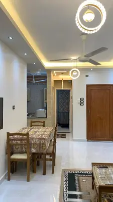 a dining room with a table and chairs and a chandelier at Roma Apartment ( Center Of Hurghada, Sheraton Road ) in Hurghada