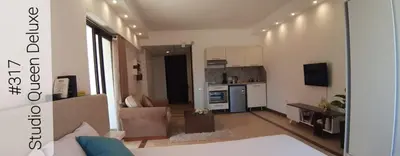 a living room with a couch and a kitchen at Alia Beach Residence in Hurghada