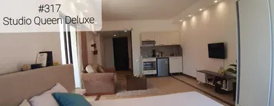 a living room with a couch and a kitchen at Alia Beach Residence in Hurghada
