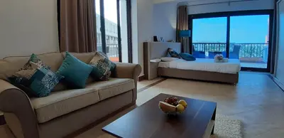 a living room with a couch and a table at Alia Beach Residence in Hurghada
