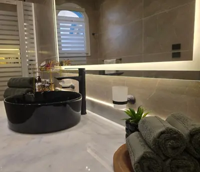 a bathroom with a large black tub in a room at Luxury Royal Blue Family Villa 8pers private pool in Hurghada