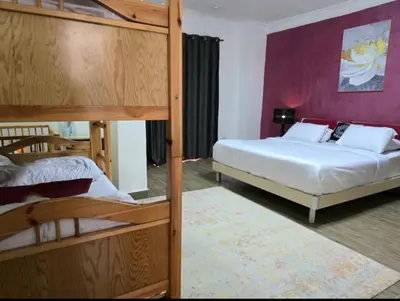 a bedroom with two bunk beds and a purple wall at Luxury Royal Blue Family Villa 8pers private pool in Hurghada