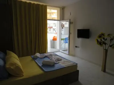 a bedroom with a bed and a sliding glass door at Apartment Bella Donna near the sea RedSeaLine. in Hurghada