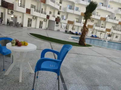 a table and chairs in front of a building at Apartment Bella Donna near the sea RedSeaLine. in Hurghada