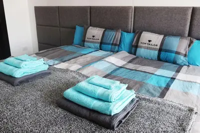 a bed with blue pillows on top of it at Sky Star Villa 25 in Hurghada