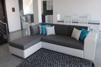 a couch with blue and white pillows in a living room at Sky Star Villa 25 in Hurghada