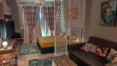 a living room with a couch and a table at Stylish Pool view studio in Al Dau Heights in Hurghada