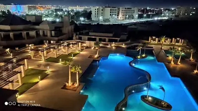 a view of a hotel pool at night at Stylish Pool view studio in Al Dau Heights in Hurghada