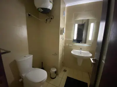 a small bathroom with a toilet and a sink at Stylish Pool view studio in Al Dau Heights in Hurghada