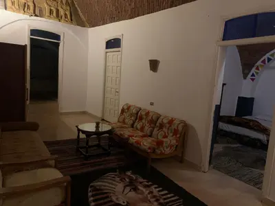 a living room with a couch and a table at Nubian Farm Aswan in Aswan