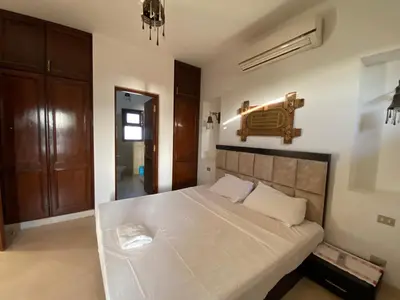 a bedroom with a large white bed in a room at Sabina El Gouna - Pool and Lagoon Ap-2 in Hurghada