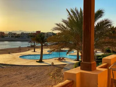 a resort with a swimming pool and palm trees at Sabina El Gouna - Pool and Lagoon Ap-2 in Hurghada