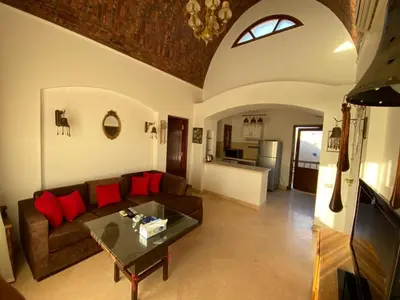 a living room with a couch and a table at Sabina El Gouna - Pool and Lagoon Ap-2 in Hurghada