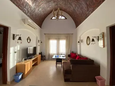 a living room with a couch and a tv at Sabina El Gouna - Pool and Lagoon Ap-2 in Hurghada