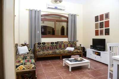 a living room with a couch and a tv at Habibi Nubian Guest House-Nubian Hospitality in Aswan