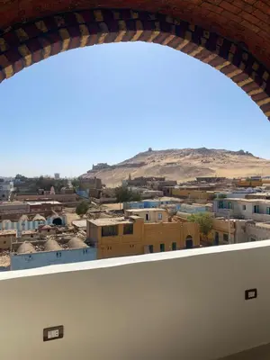 a view of a city from a window at Habibi Nubian Guest House-Nubian Hospitality in Aswan