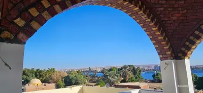 an arch in a building with a view of the water at Habibi Nubian Guest House-Nubian Hospitality in Aswan
