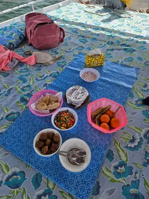a table with plates of food and bowls of food at Felucca Sailing Boat Overnight Experience in Aswan