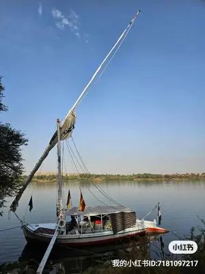 a boat is docked on the water at Felucca Sailing Boat Overnight Experience in Aswan