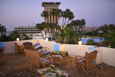 a group of chairs and a table and a building at Kosh royal house in Aswan