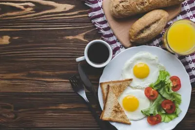 a plate of eggs and toast and a cup of coffee at Kosh royal house in Aswan