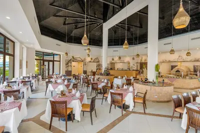 a dining room with tables and chairs and a restaurant at Steigenberger Aqua Magic, All inclusive in Hurghada