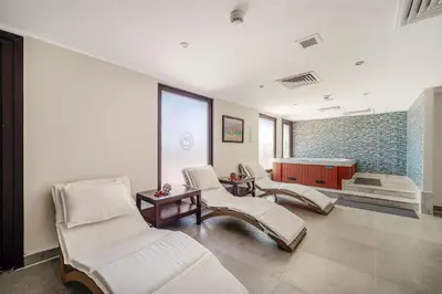 a waiting room with white chairs and a tub at Steigenberger Aqua Magic, All inclusive in Hurghada