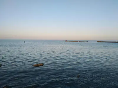 a large body of water with rocks in it at Studio Apartment at Tiba Star in Hurghada