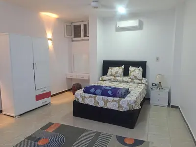 a bedroom with a bed and a white wall at Sweet Home- ممنوع للمصريين Open 24 Hour in Hurghada