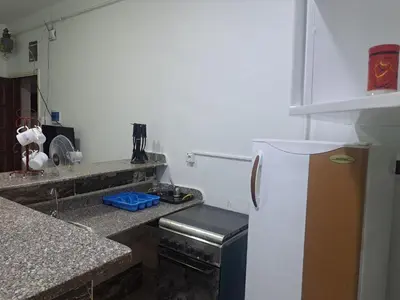 a kitchen with a white refrigerator and granite counter tops at Sweet Home- ممنوع للمصريين Open 24 Hour in Hurghada